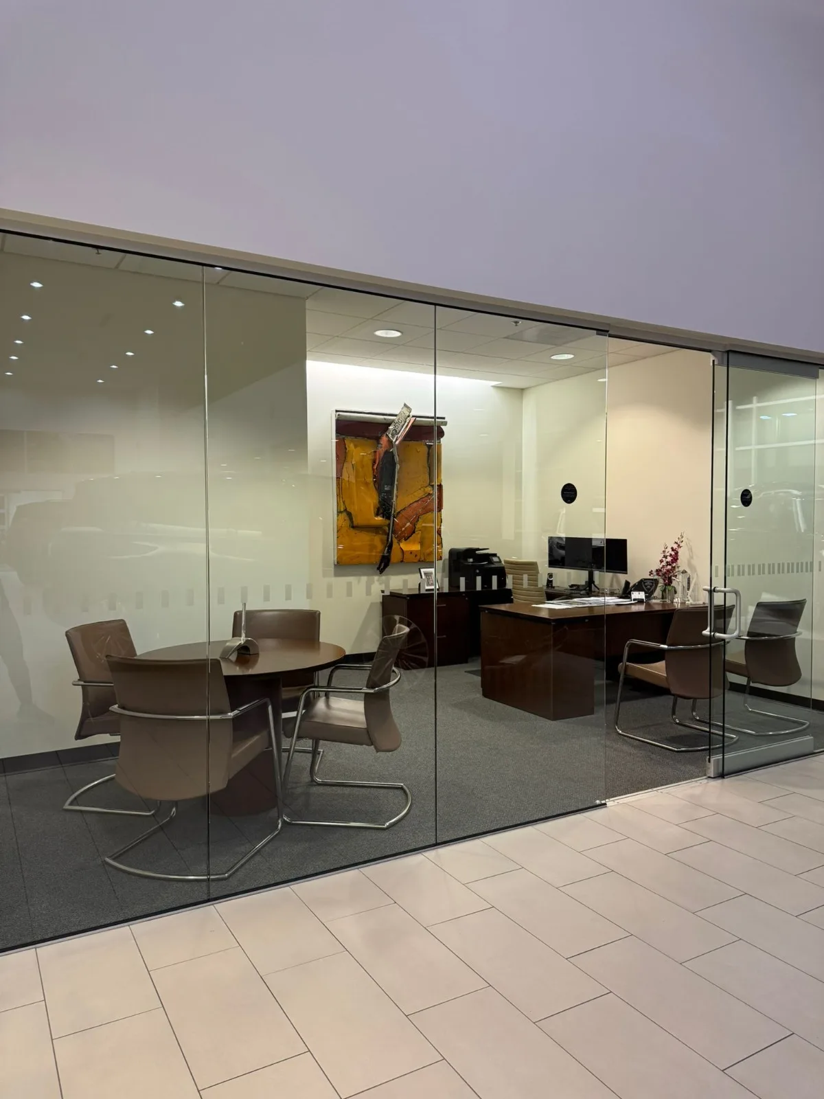Clean private office with glass walls serviced by Empire